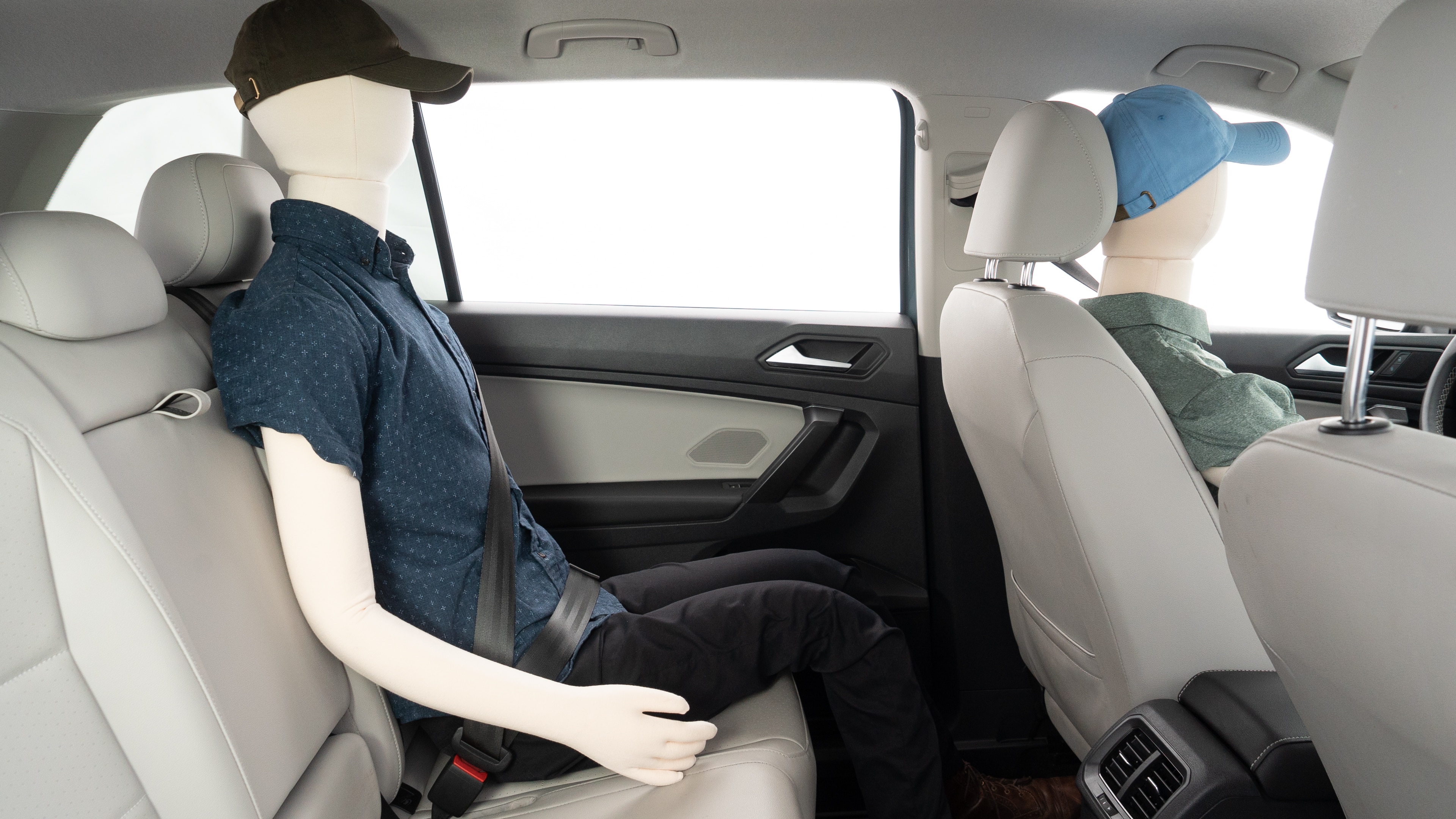 A series of second-row backseat photos is shown including one seating a baby seat and one seating a 6'1" mannequin.