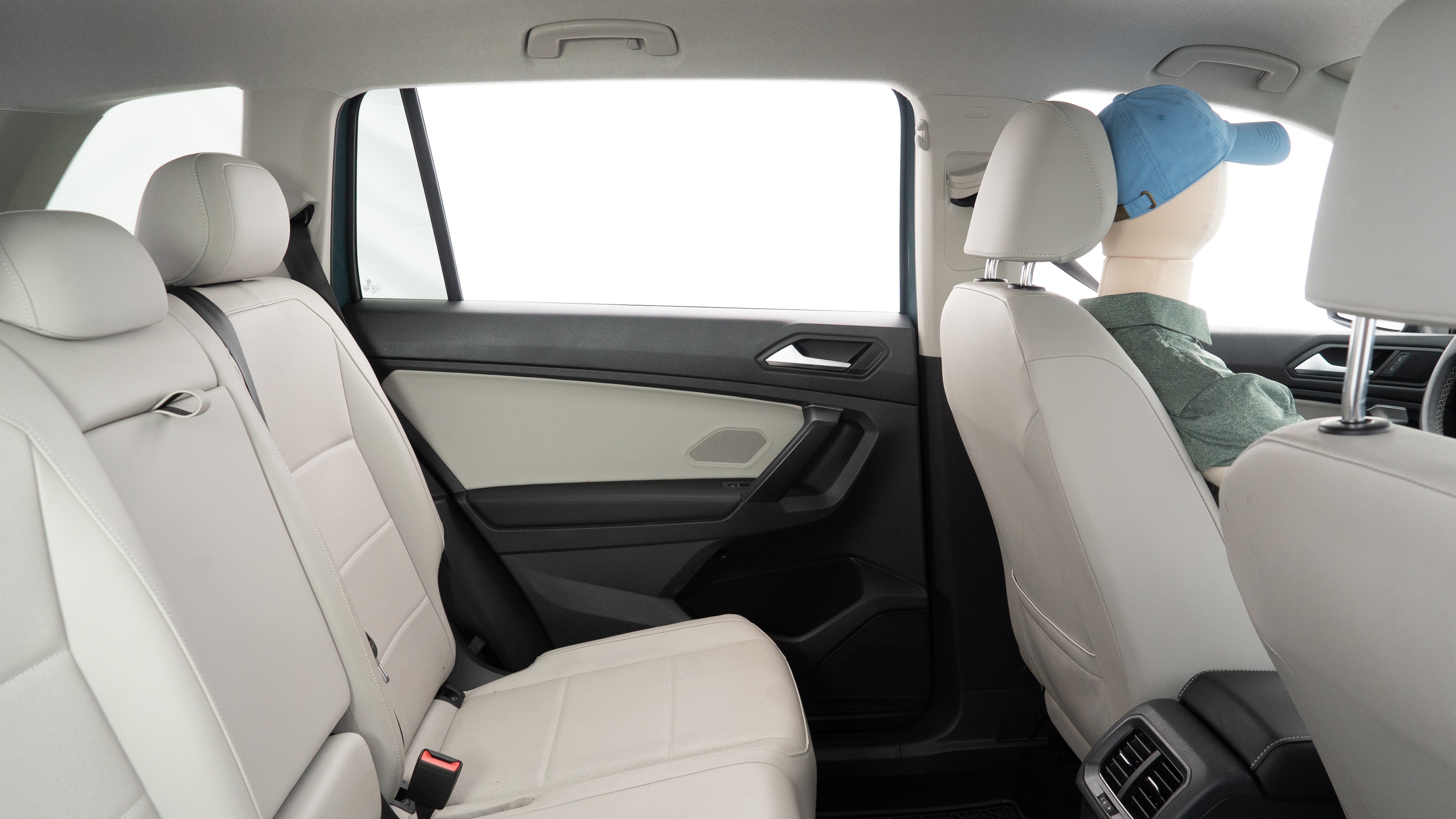 A series of second-row backseat photos is shown including one seating a baby seat and one seating a 6'1" mannequin.