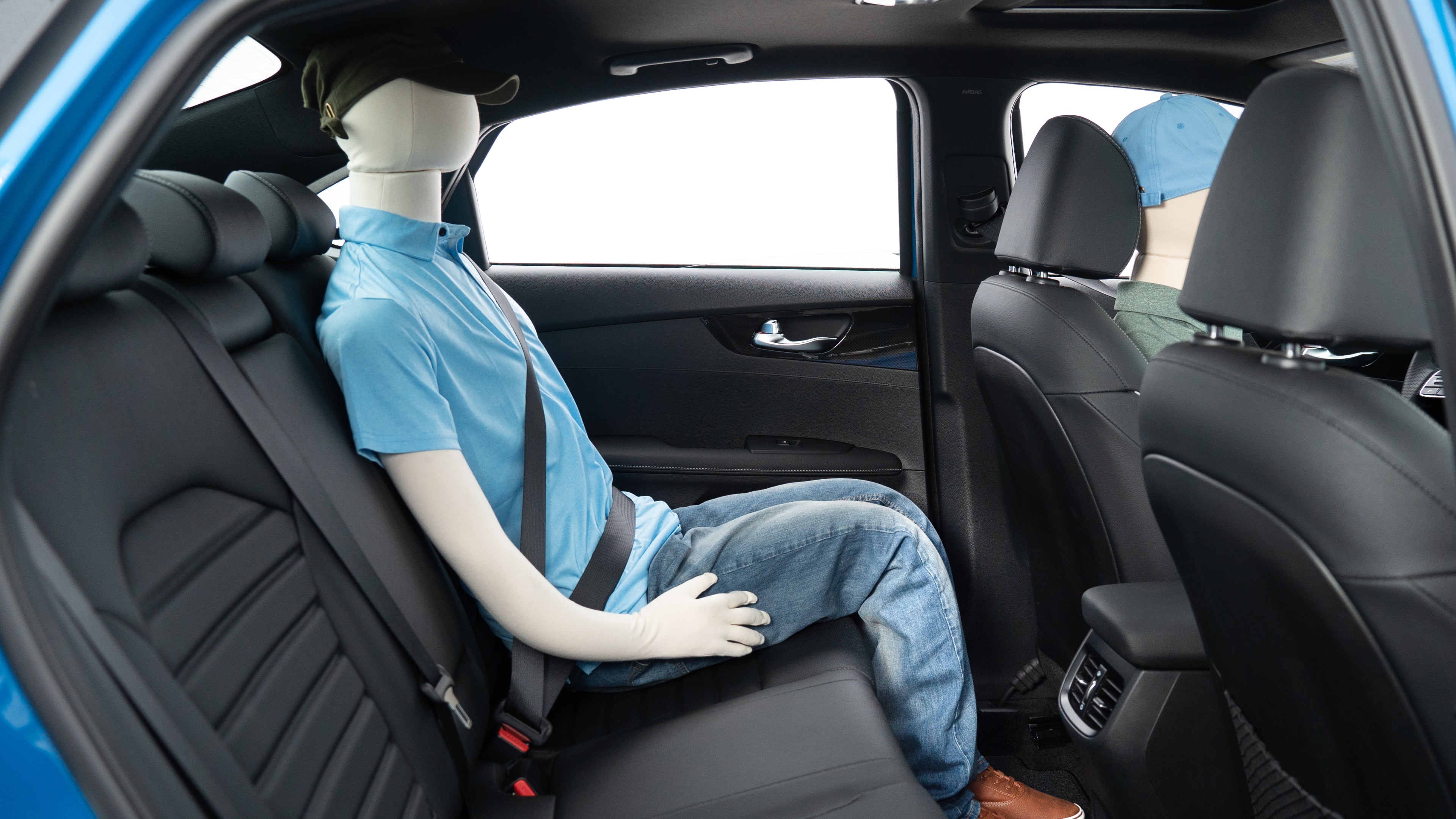 : A series of second-row backseat photos is shown including one seating a baby seat, a dog and one seating a 6'1" mannequin.