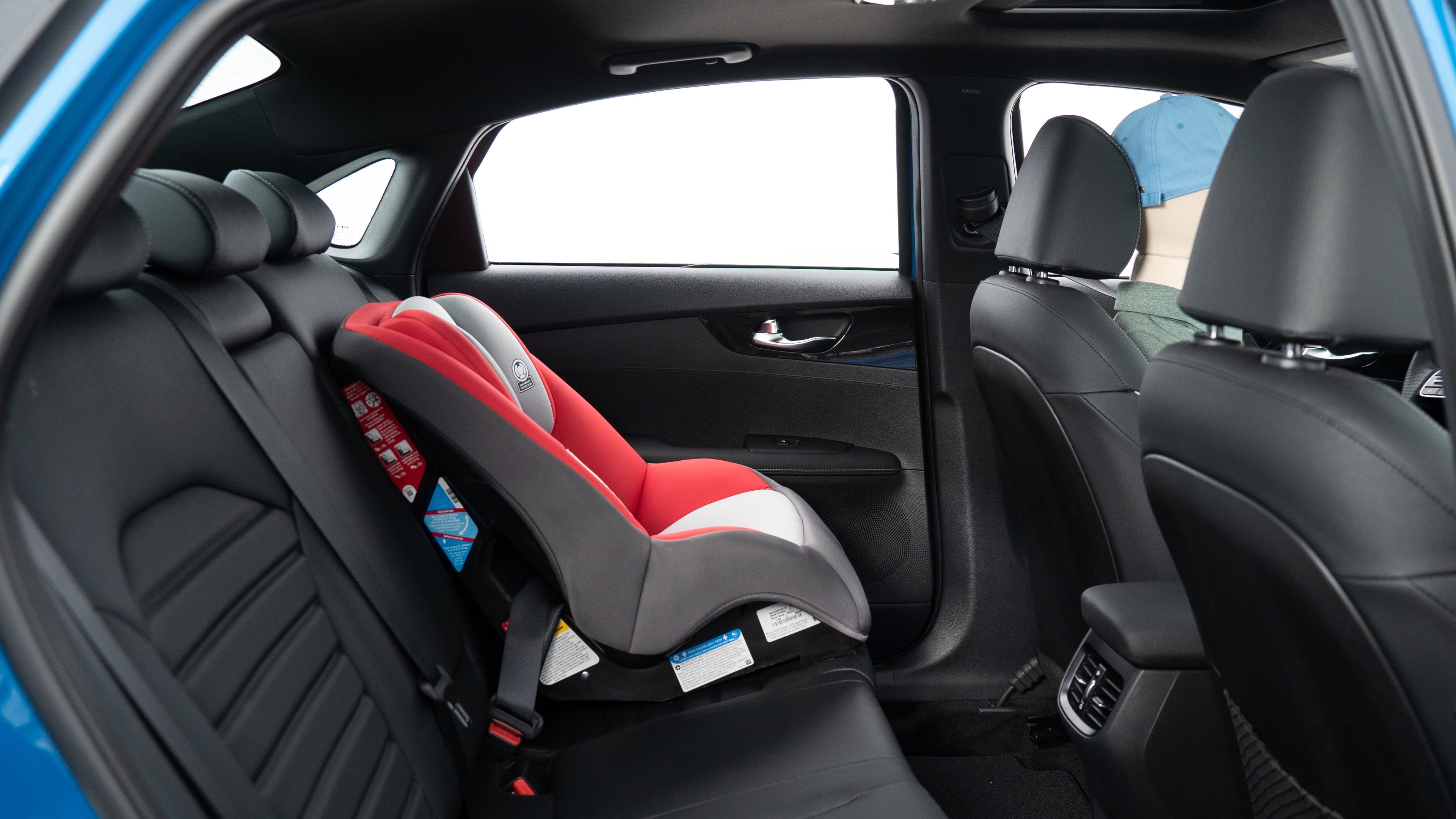 : A series of second-row backseat photos is shown including one seating a baby seat, a dog and one seating a 6'1" mannequin.