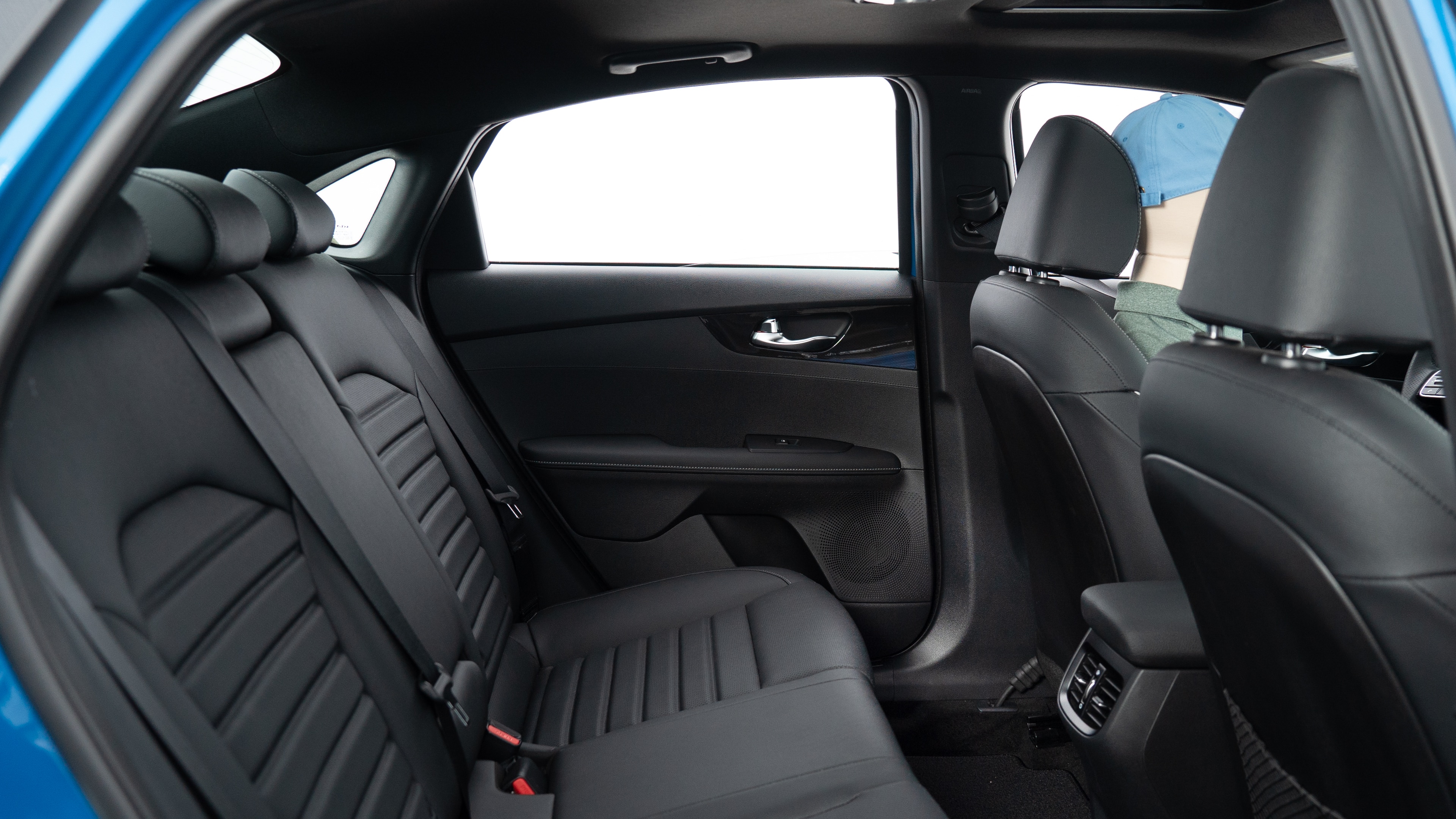 : A series of second-row backseat photos is shown including one seating a baby seat, a dog and one seating a 6'1" mannequin.