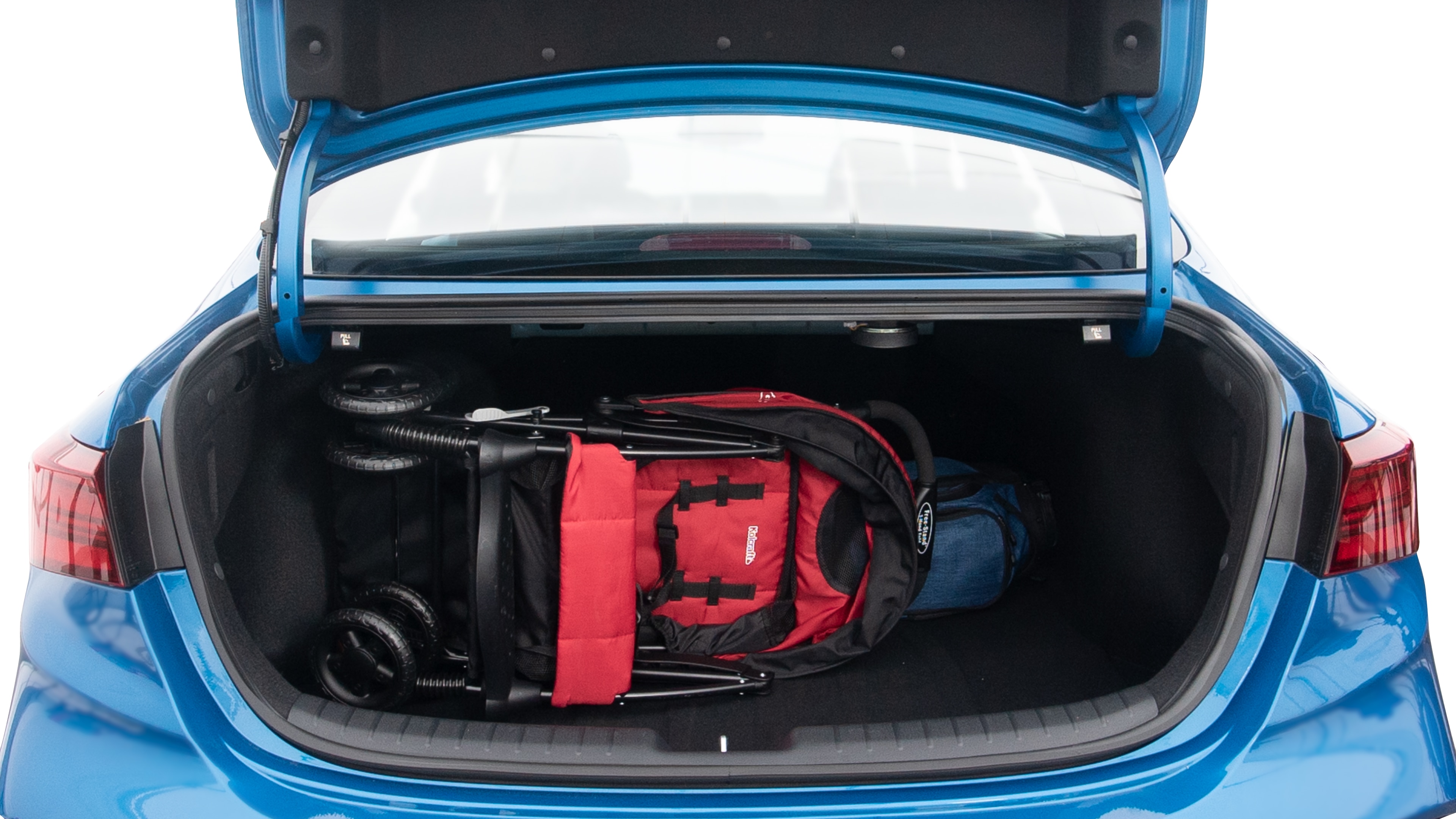 The trunk lid is open showing full view of the trunk. A baby stroller, three grocery carriers, two camping chairs in the carrying bag, and a set of golf clubs are placed inside.