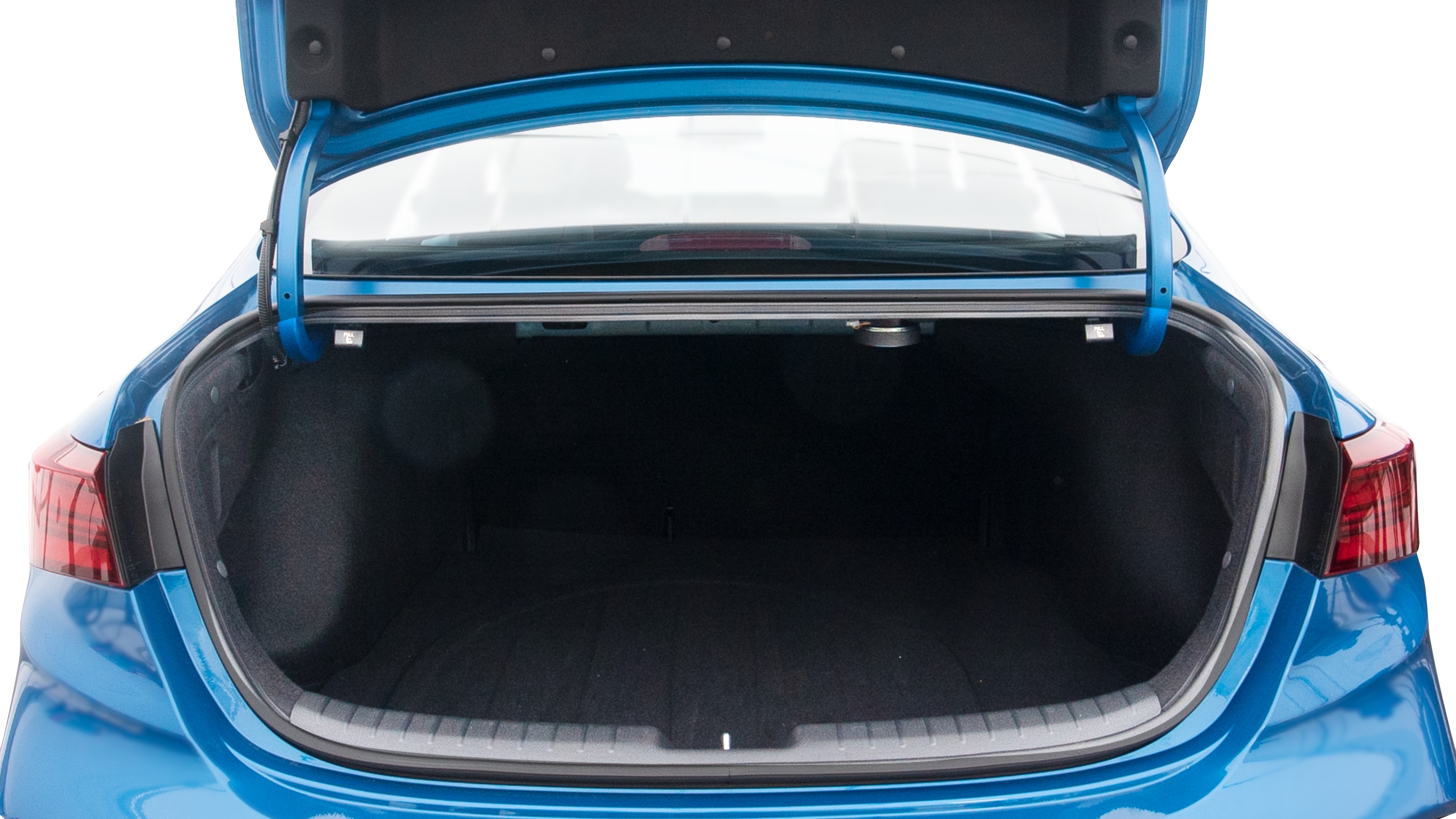 The trunk lid is open, showing full view of the trunk space. Two large and two small suitcases are placed inside.