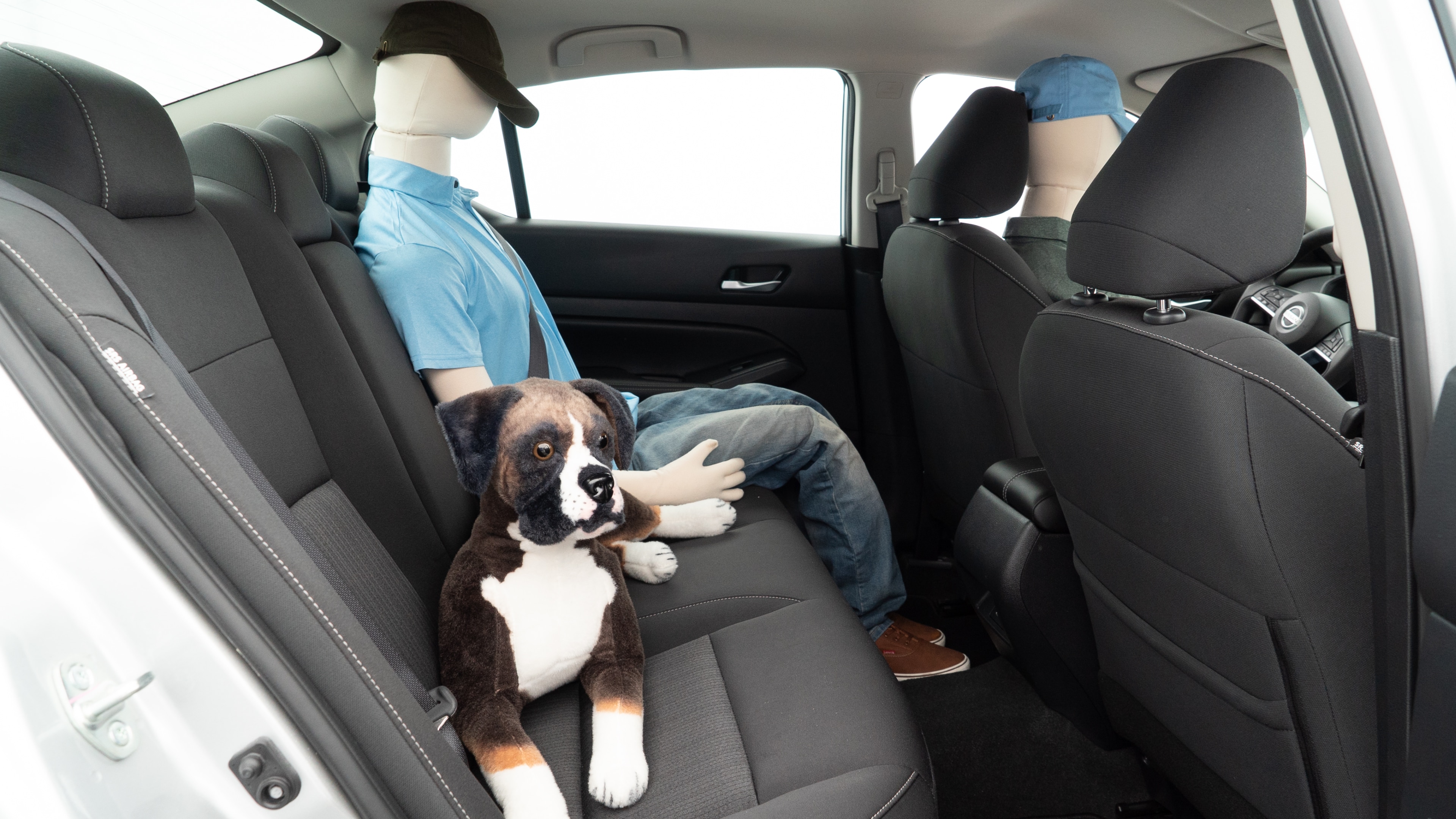 A series of second-row backseat photos is shown including one seating a baby seat and one seating a 6'1" mannequin.