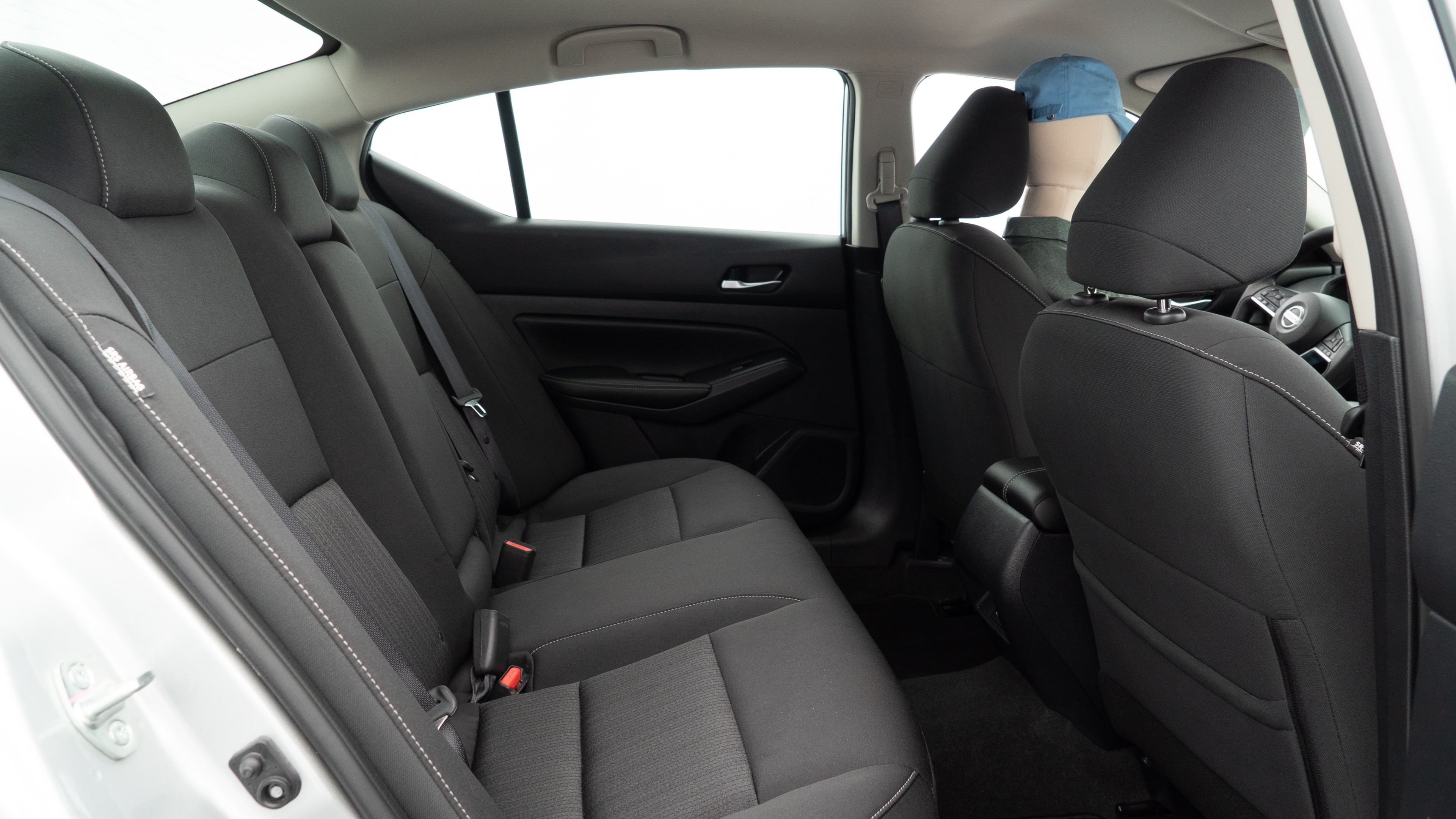 A series of second-row backseat photos is shown including one seating a baby seat and one seating a 6'1" mannequin.