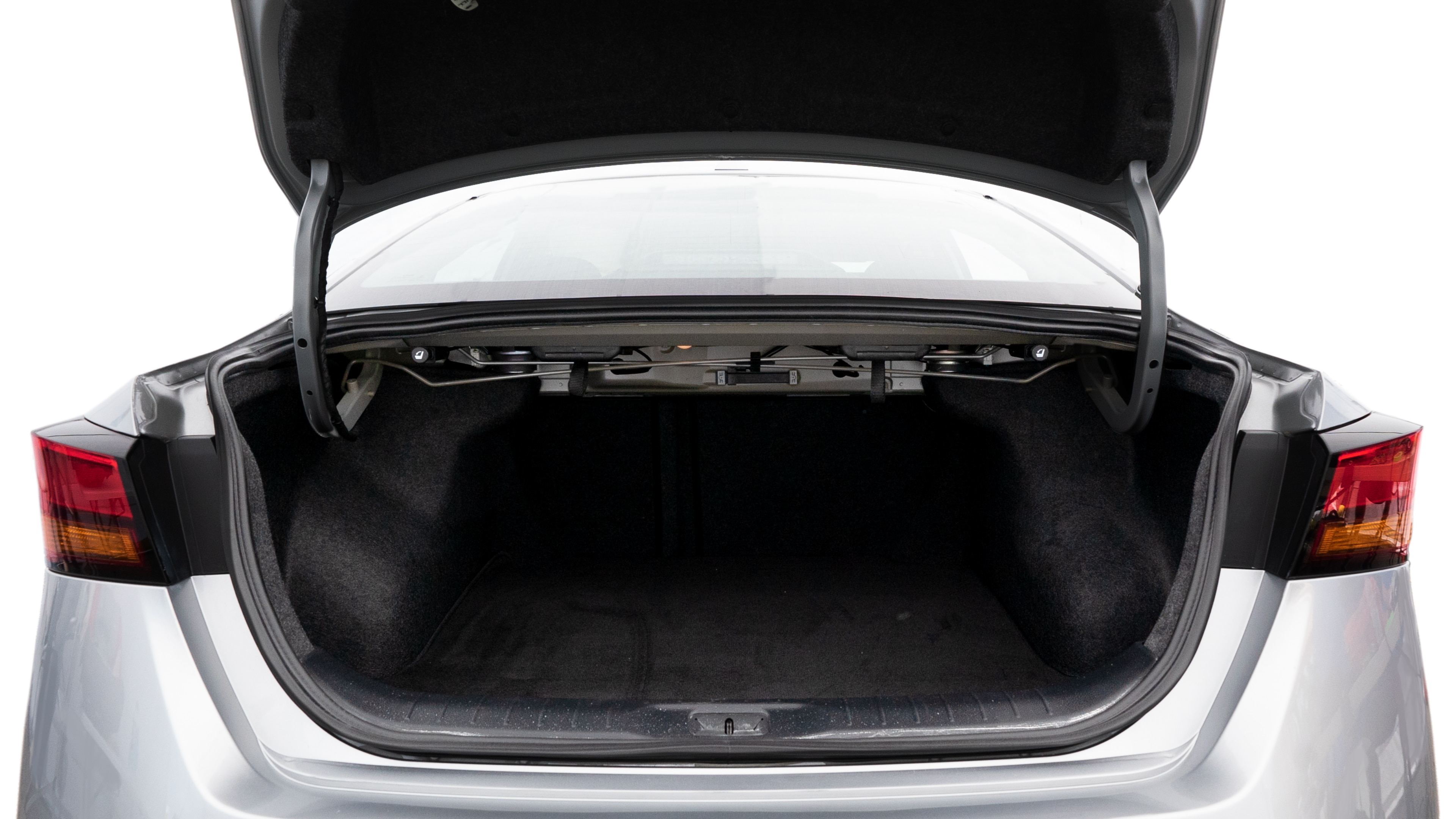 The trunk lid is open showing full view of the trunk. A baby stroller, three grocery carriers, two camping chairs in the carrying bag, and a set of golf clubs are placed inside.