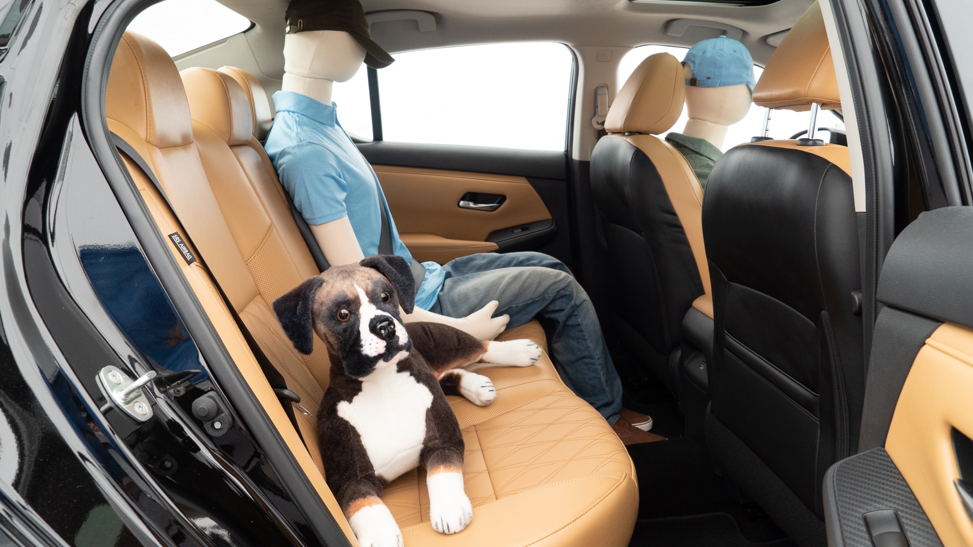 A series of second-row backseat photos is shown including one seating a baby seat and one seating a 6'1" mannequin.