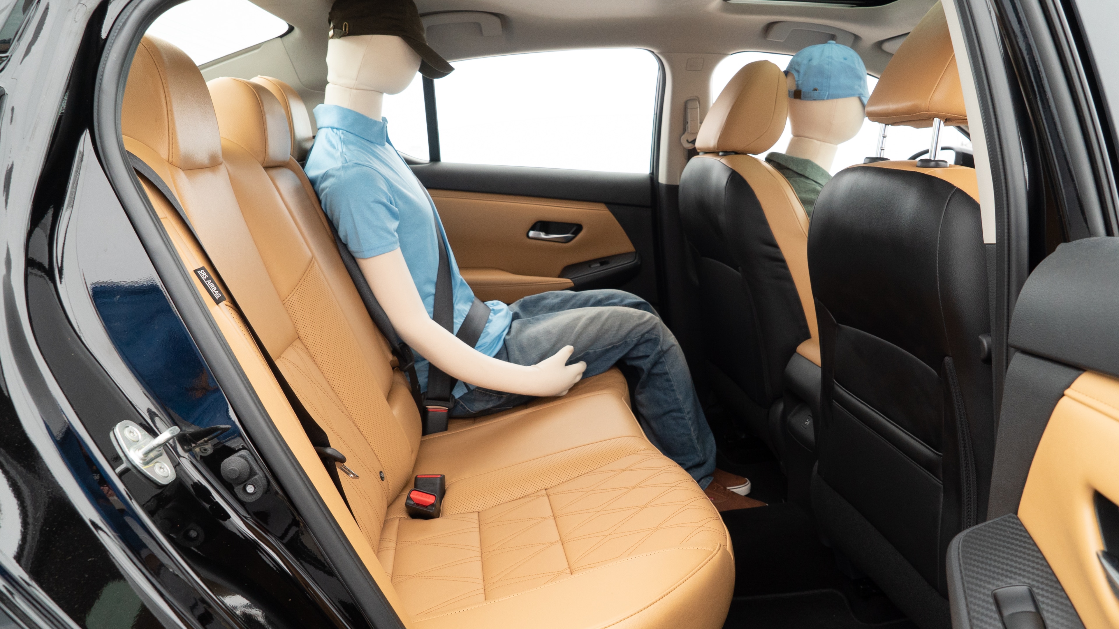 A series of second-row backseat photos is shown including one seating a baby seat and one seating a 6'1" mannequin.