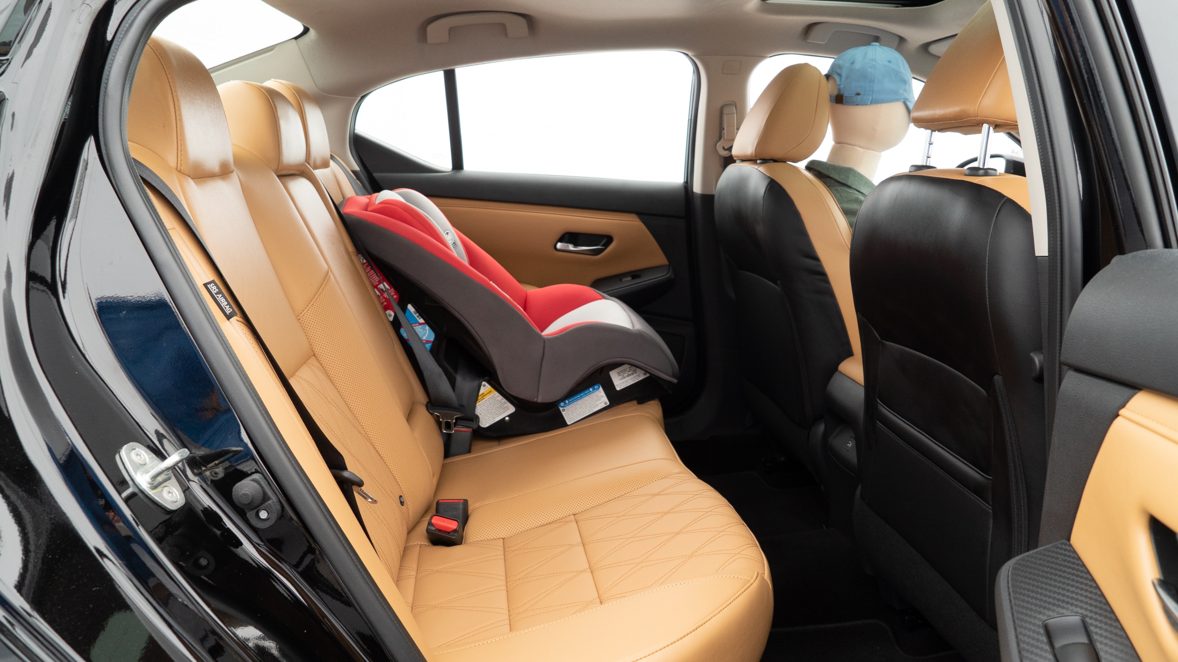 A series of second-row backseat photos is shown including one seating a baby seat and one seating a 6'1" mannequin.