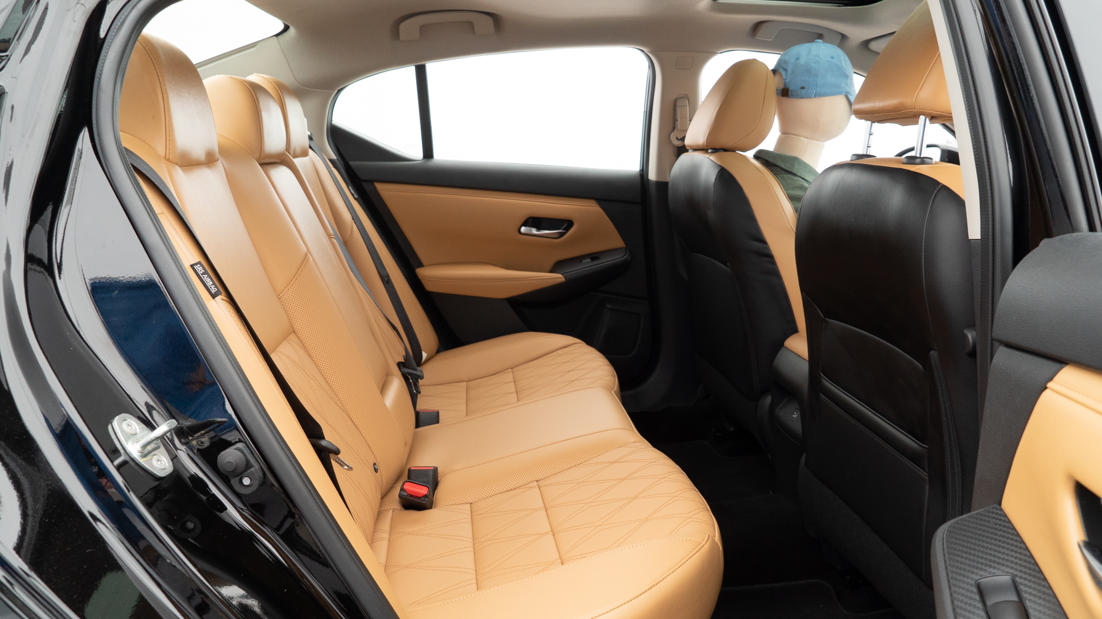 A series of second-row backseat photos is shown including one seating a baby seat and one seating a 6'1" mannequin.