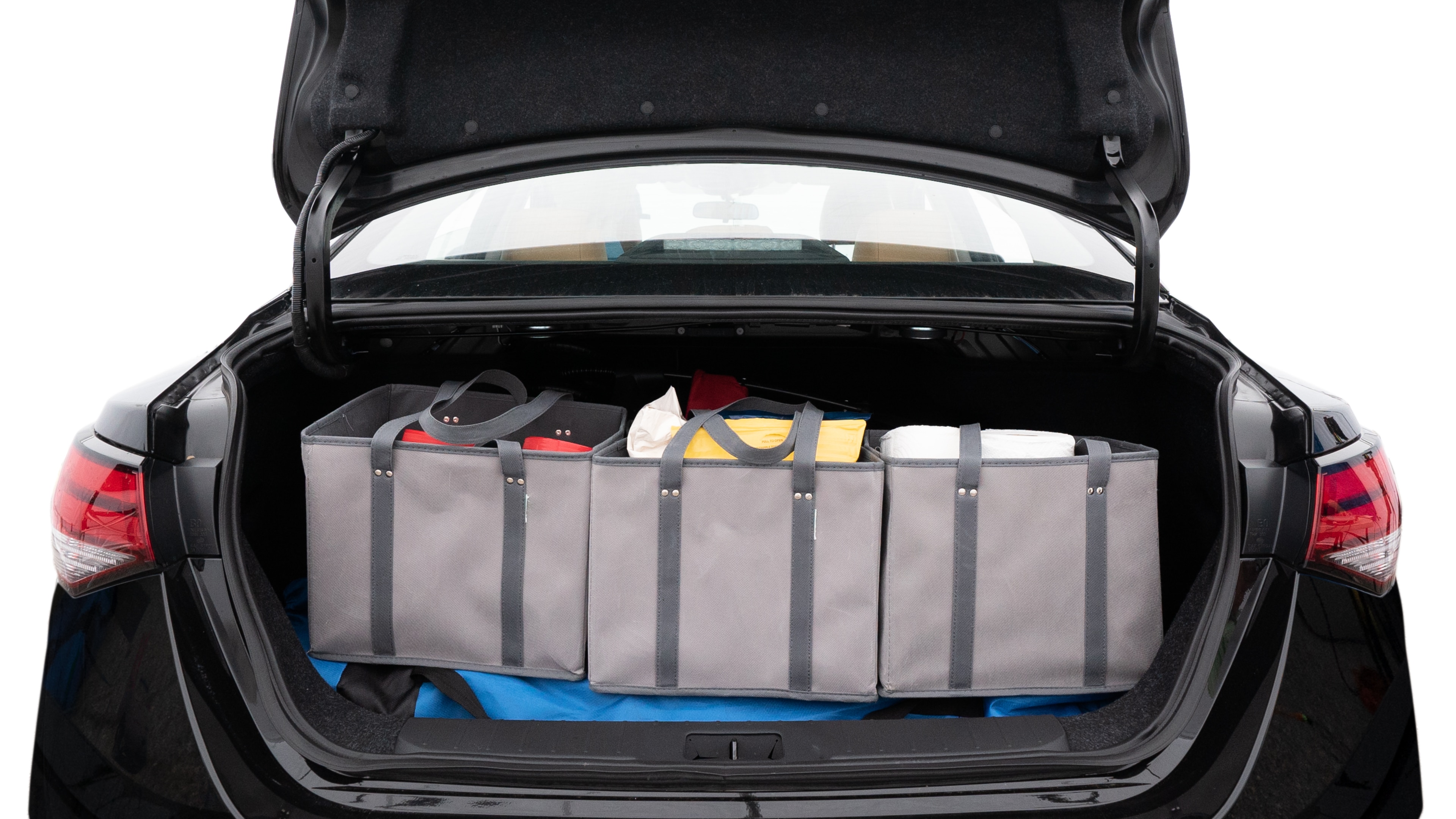 The trunk lid is open showing full view of the trunk. A baby stroller, three grocery carriers, two camping chairs in the carrying bag, and a set of golf clubs are placed inside.