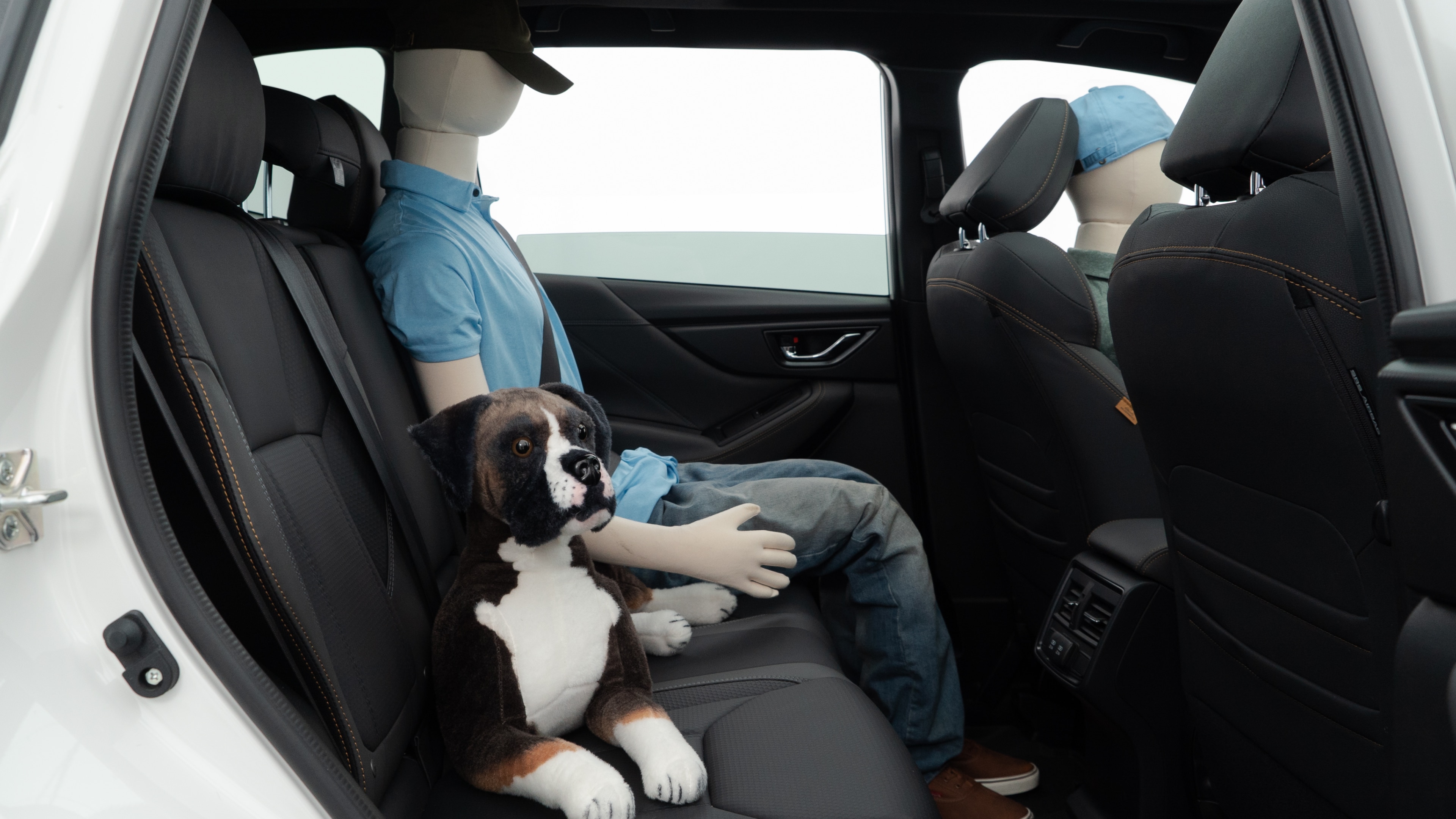 A series of second-row backseat photos is shown including one seating a baby seat and one seating a 6'1" mannequin.