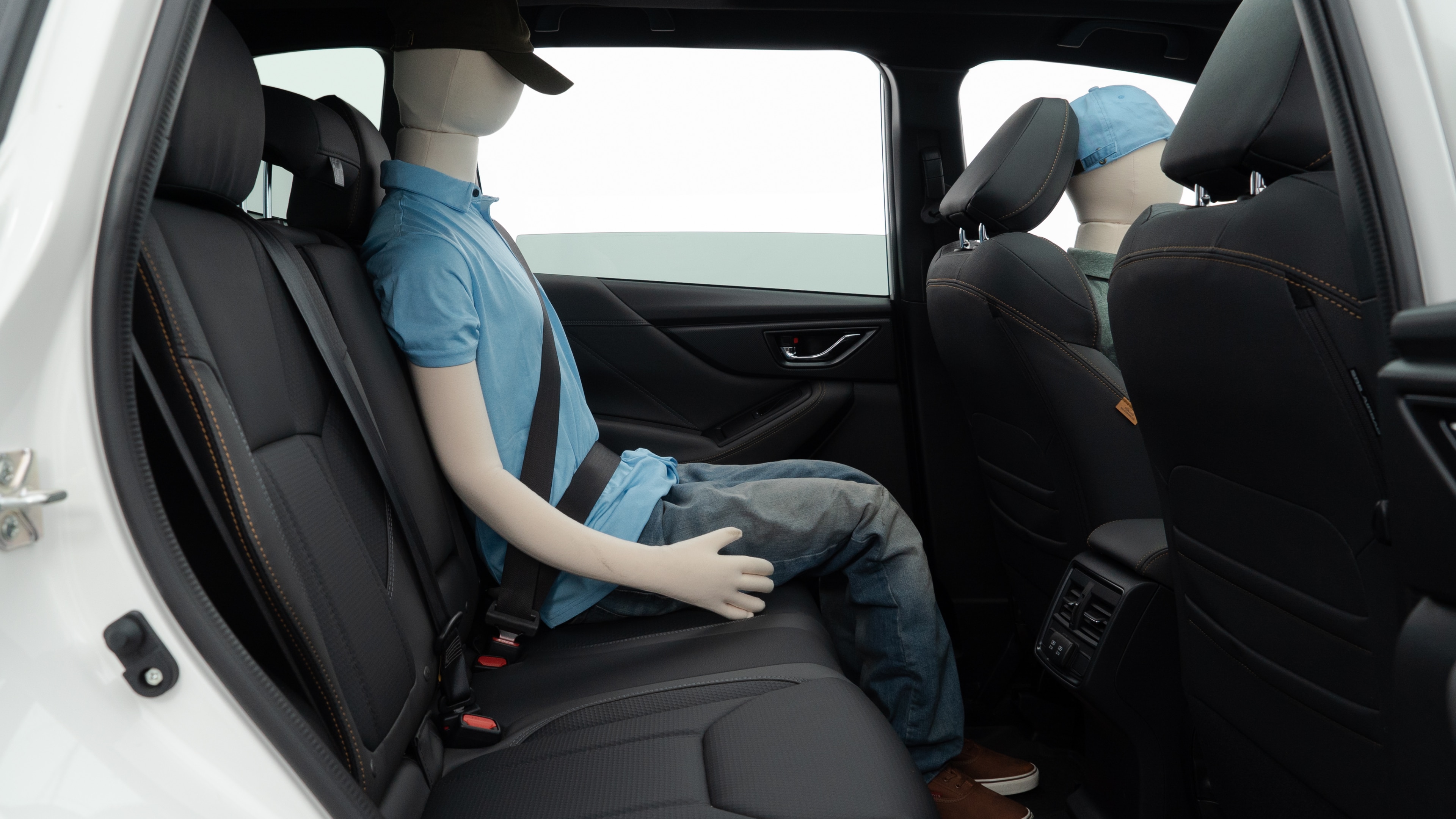 A series of second-row backseat photos is shown including one seating a baby seat and one seating a 6'1" mannequin.