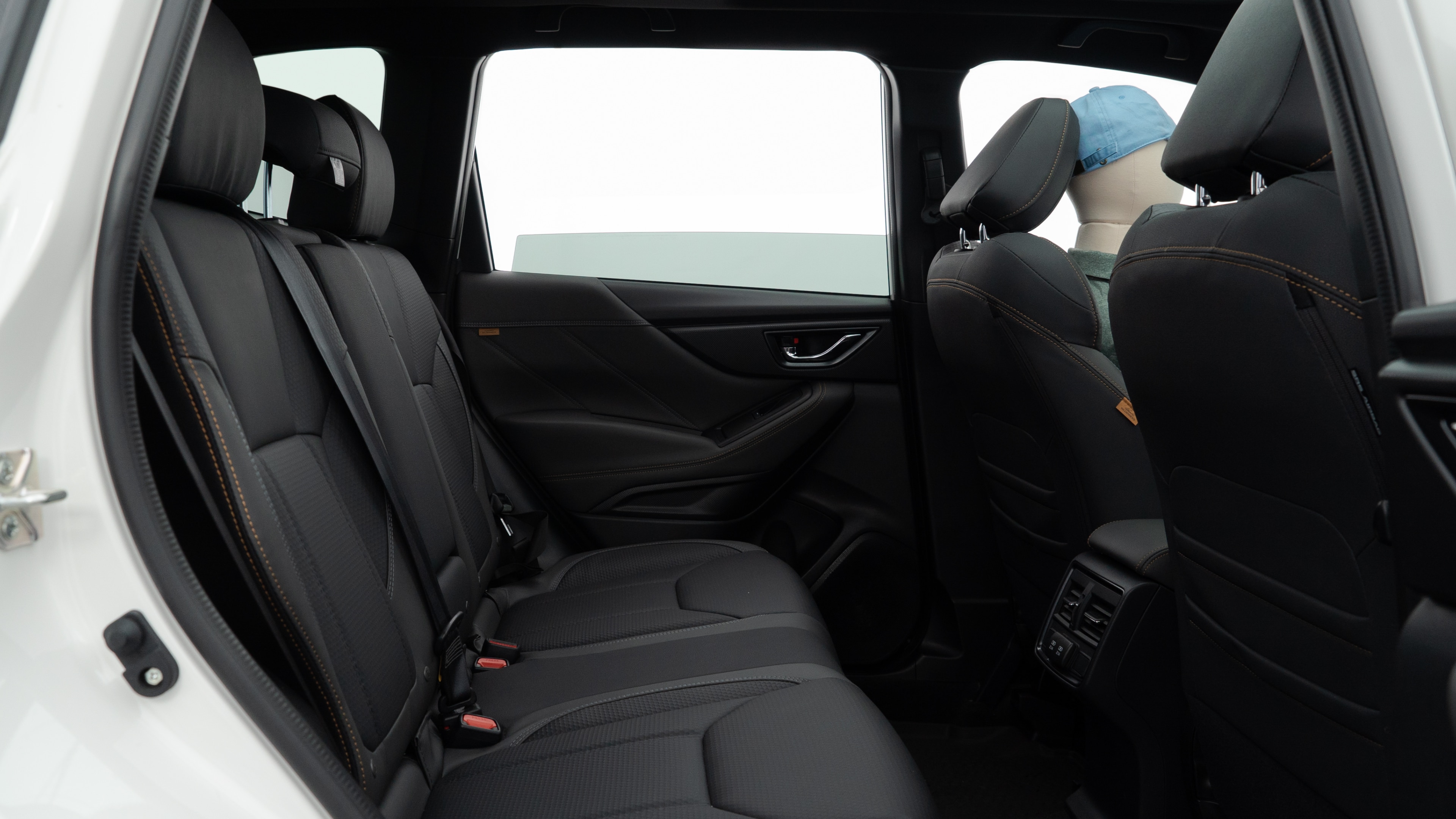 A series of second-row backseat photos is shown including one seating a baby seat and one seating a 6'1" mannequin.