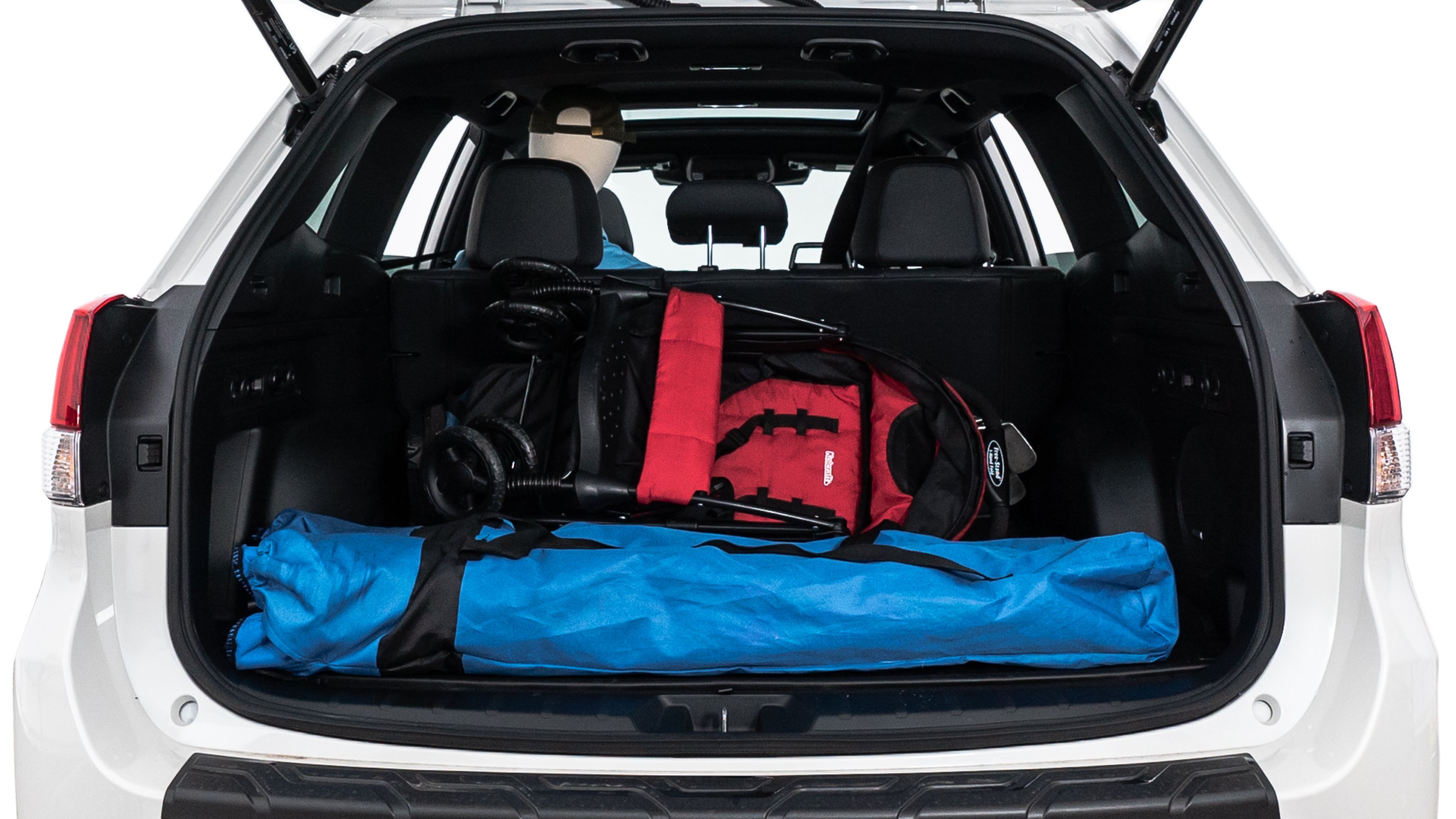 The trunk lid is open showing full view of the trunk. A baby stroller, three grocery carriers, two camping chairs in the carrying bag, and a set of golf clubs are placed inside.