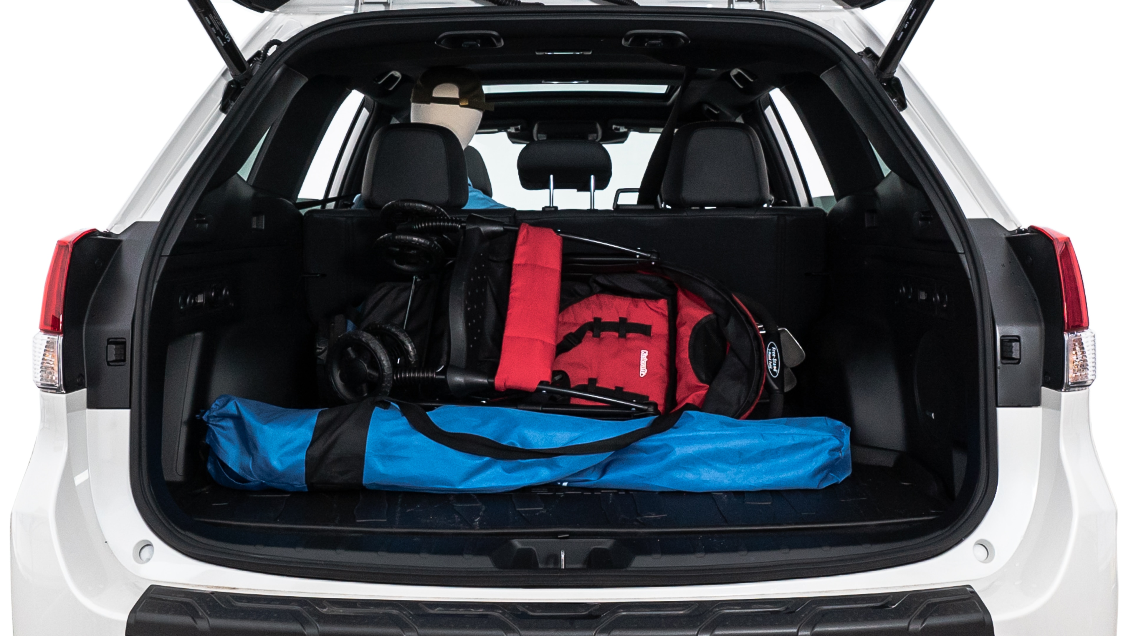 The trunk lid is open showing full view of the trunk. A baby stroller, three grocery carriers, two camping chairs in the carrying bag, and a set of golf clubs are placed inside.
