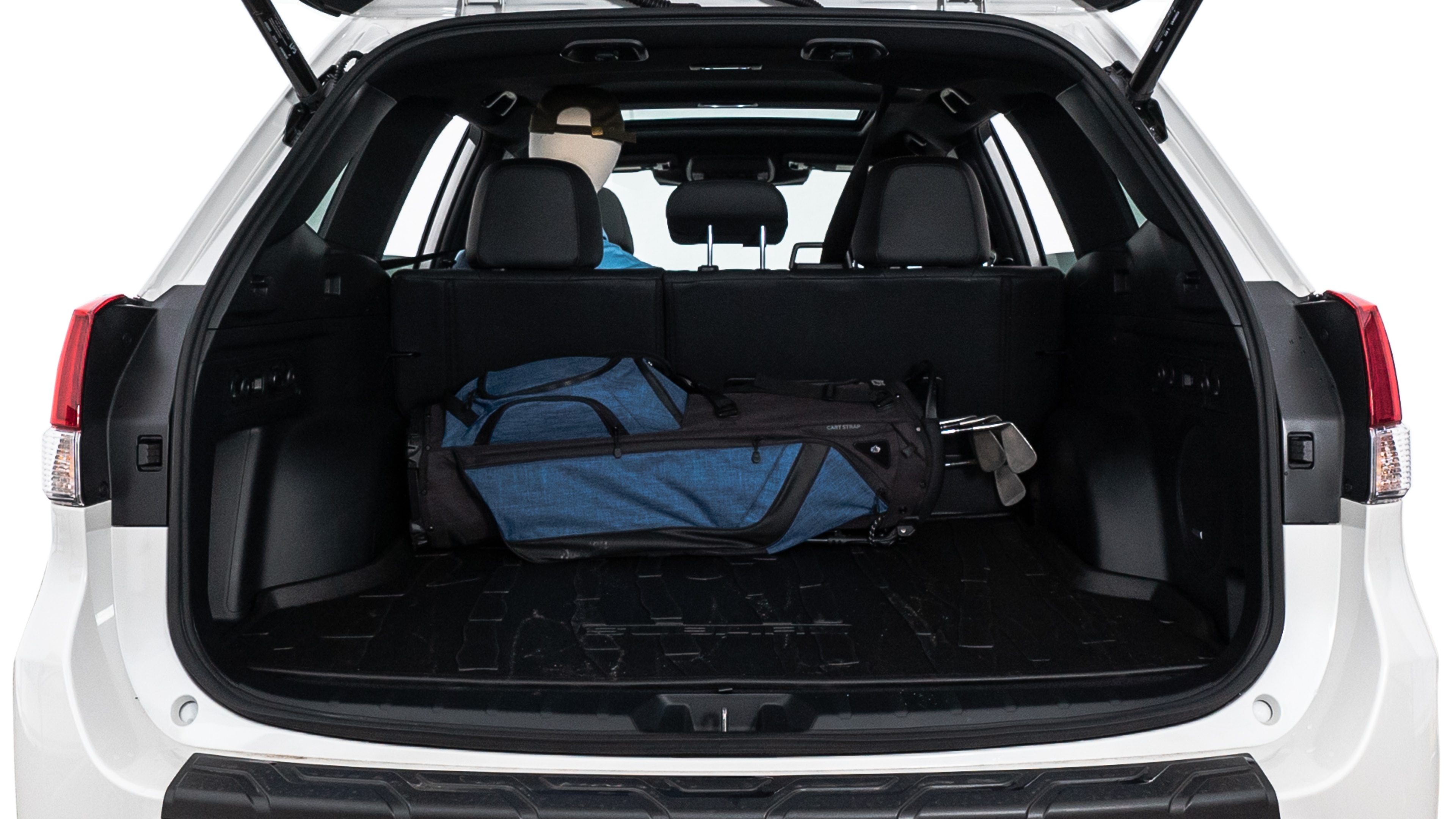 The trunk lid is open showing full view of the trunk. A baby stroller, three grocery carriers, two camping chairs in the carrying bag, and a set of golf clubs are placed inside.