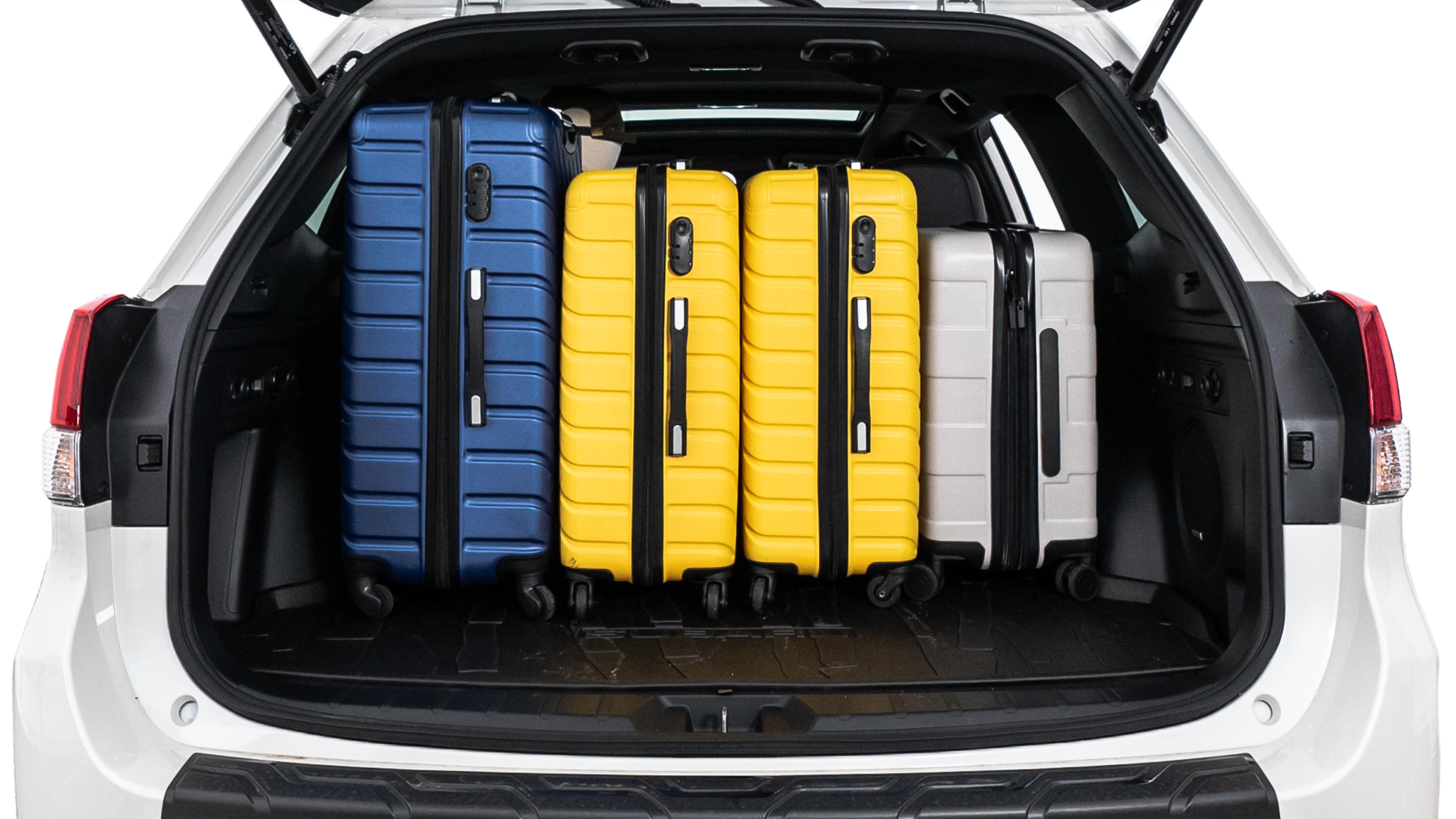 The trunk lid is open, showing full view of the trunk space. One large suitcase, two medium suitcases, and two small suitcases are placed inside.