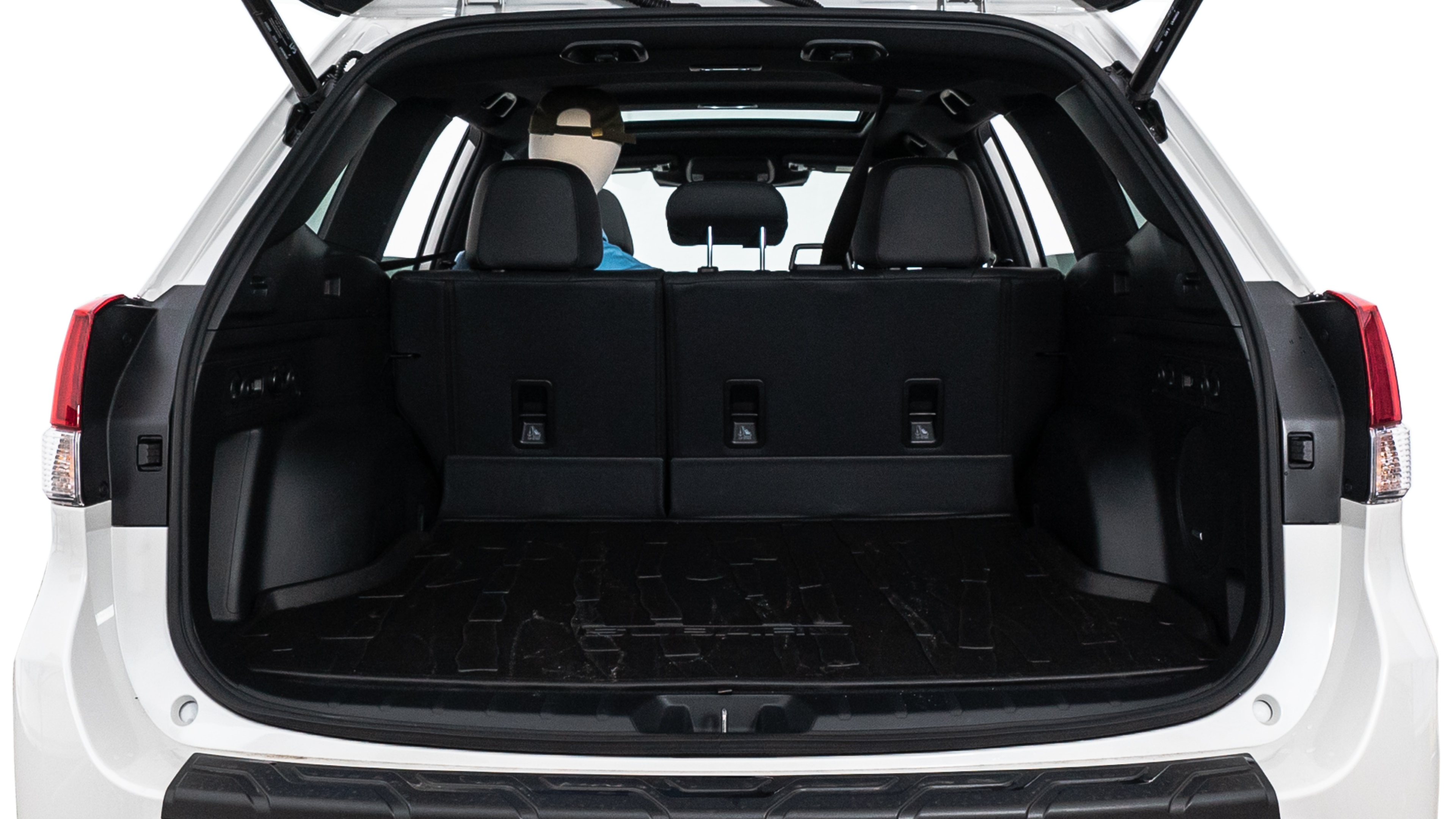 The trunk lid is open, showing full view of the trunk space. One large suitcase, two medium suitcases, and two small suitcases are placed inside.