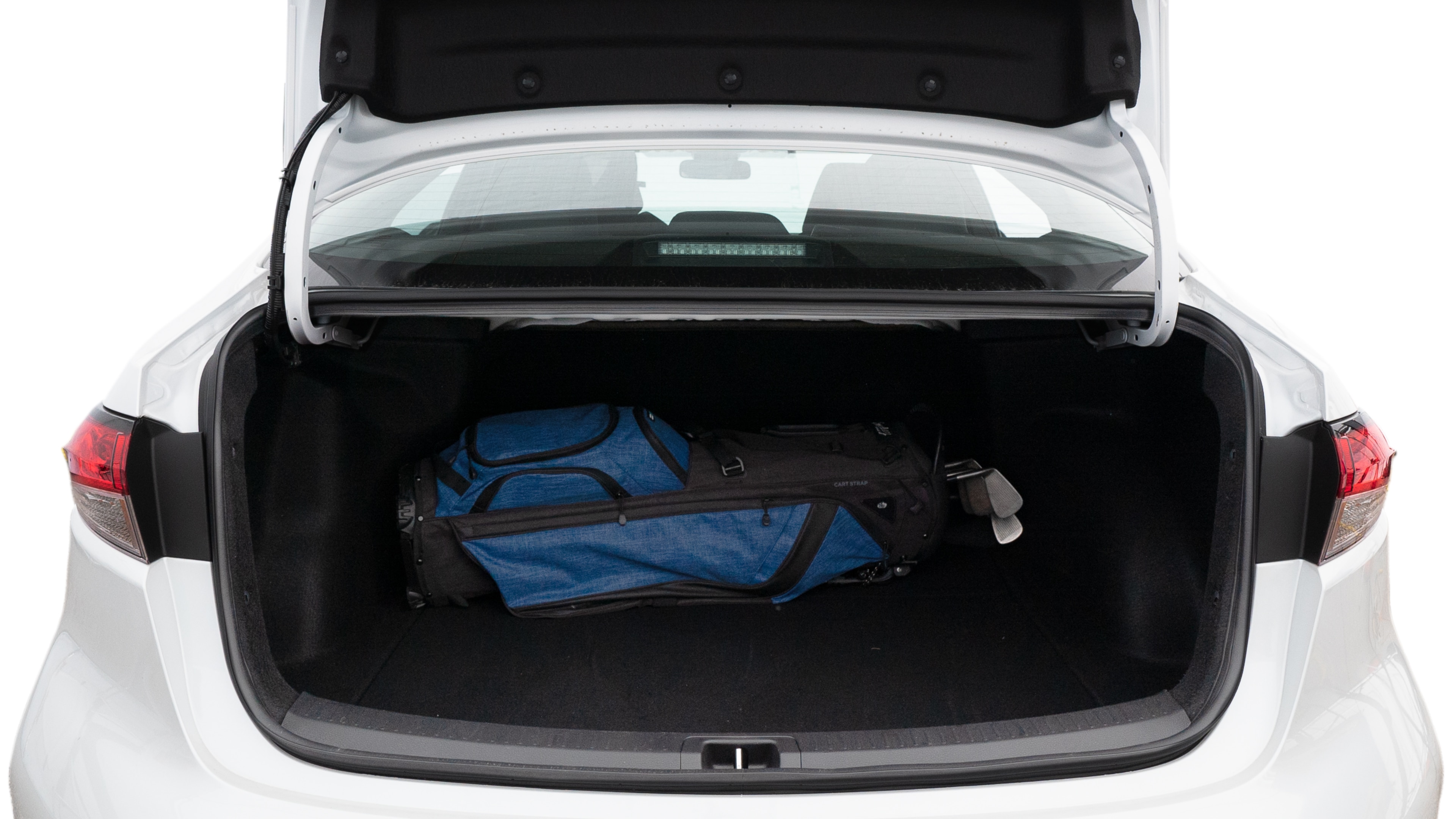 The trunk lid is open showing full view of the trunk. A baby stroller, three grocery carriers, two camping chairs in the carrying bag, and a set of golf clubs are placed inside.