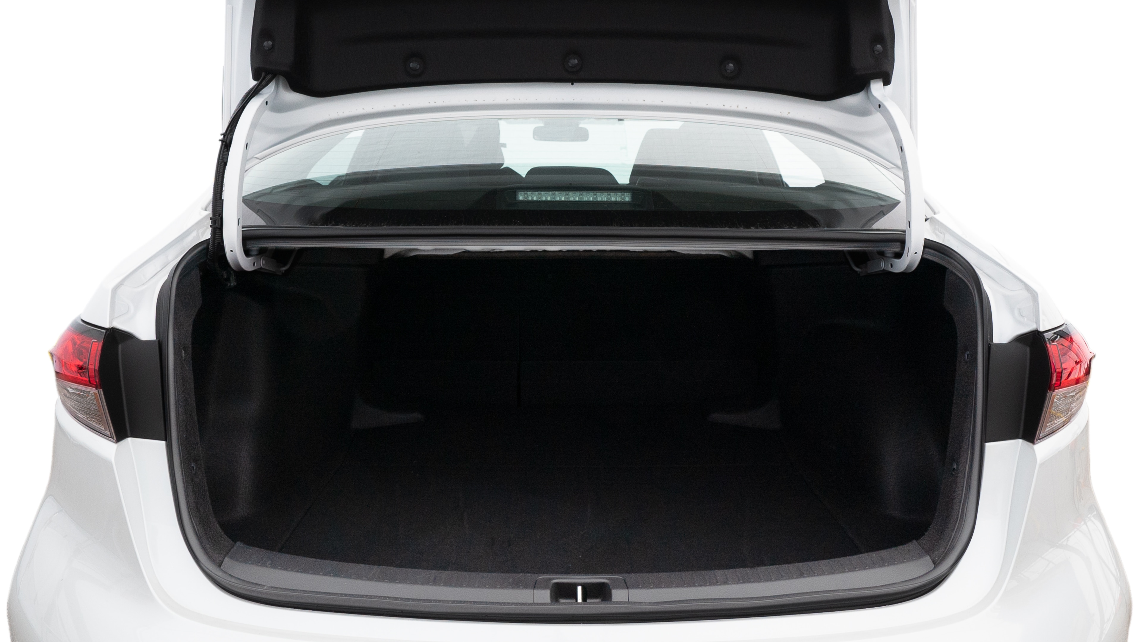 The trunk lid is open, showing full view of the trunk space. Two medium and two small suitcases are placed inside.